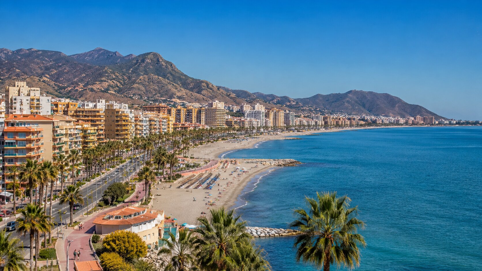 Strandpromenade und Küste an der Costa del Sol mit Bergen im Hintergrund